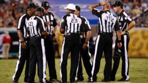 many-officials-field-during-football-game